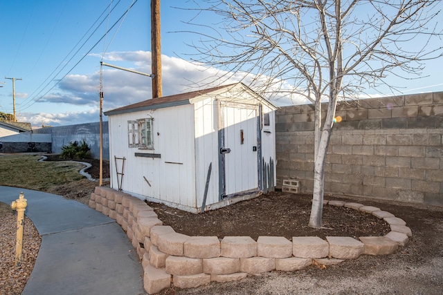 view of shed with fence