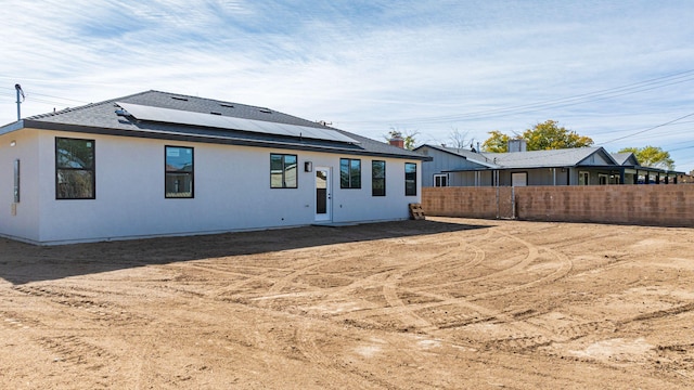 rear view of house with solar panels