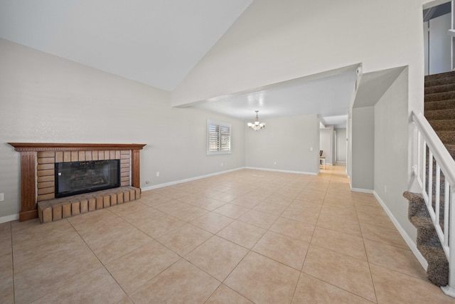 unfurnished living room with high vaulted ceiling, light tile patterned floors, a notable chandelier, and a fireplace