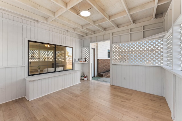 spare room featuring coffered ceiling and light hardwood / wood-style flooring