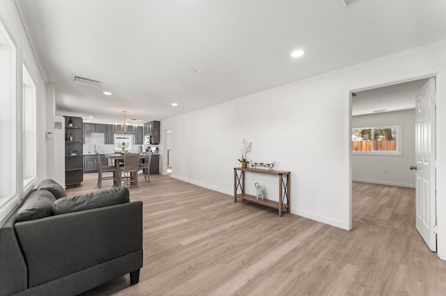 living room with crown molding and light hardwood / wood-style floors