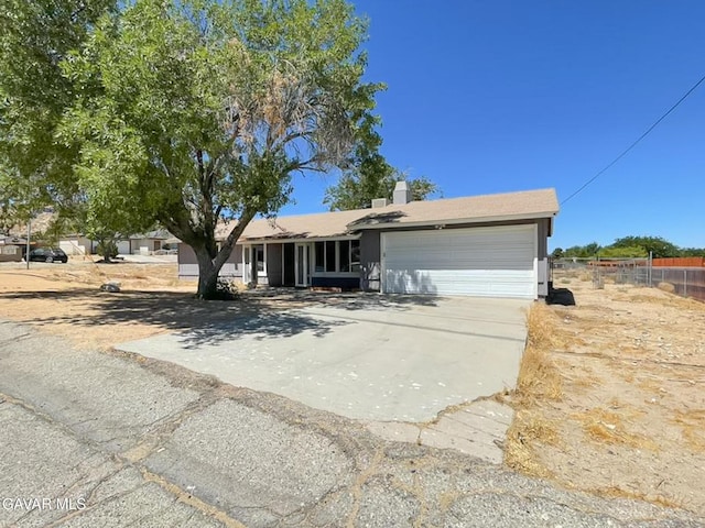 40205 E 162nd St, Palmdale, CA 93591 - view of front of property with an attached garage, concrete driveway, and a chimney