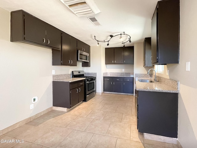 40205 E 162nd St, Palmdale, CA 93591 - kitchen with stainless steel appliances, light tile patterned floors, light stone counters, and track lighting