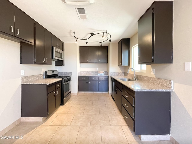 40205 E 162nd St, Palmdale, CA 93591 - kitchen with stainless steel appliances and light tile patterned floors