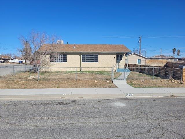 view of front of house with a fenced front yard and stucco siding