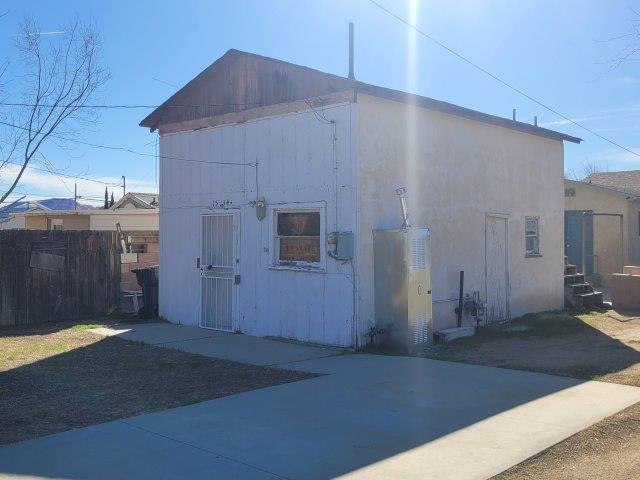 view of outbuilding featuring fence