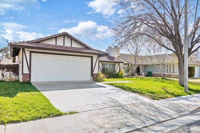 view of front facade featuring concrete driveway, a front yard, stucco siding, a chimney, and an attached garage