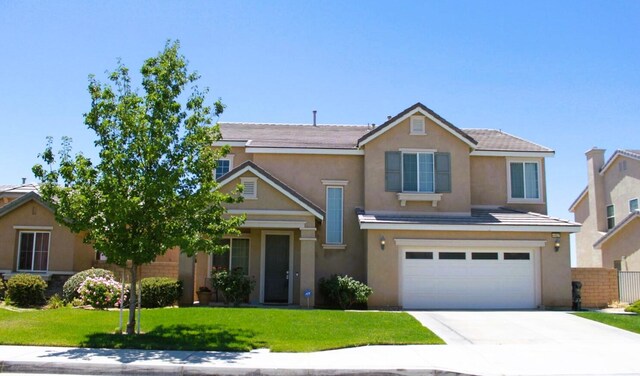 view of front of house with a garage and a front lawn