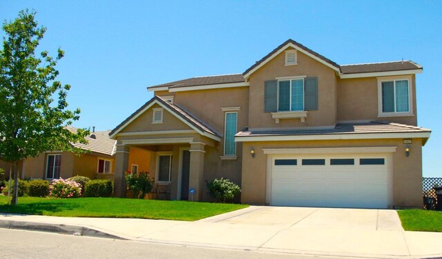 view of front of home with a garage and a front lawn