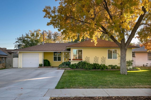 ranch-style house featuring a front lawn and a garage