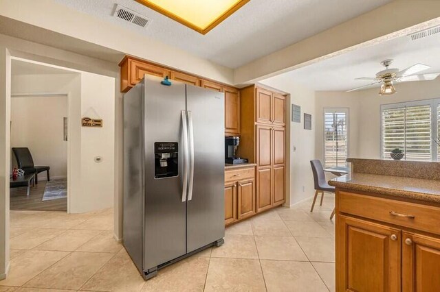 344 Vista Royal Dr, Palm Desert, CA 92211 - kitchen featuring stainless steel fridge, brown cabinetry, and visible vents