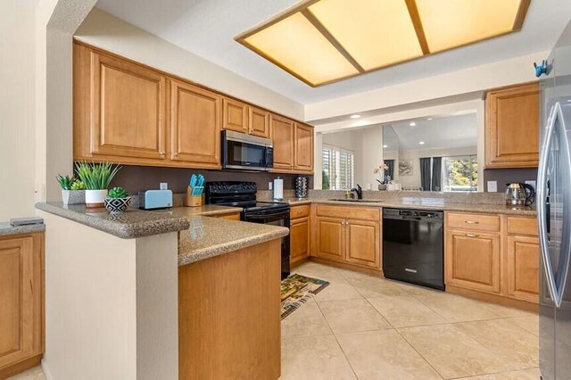 344 Vista Royal Dr, Palm Desert, CA 92211 - kitchen with a peninsula, plenty of natural light, a sink, and black appliances