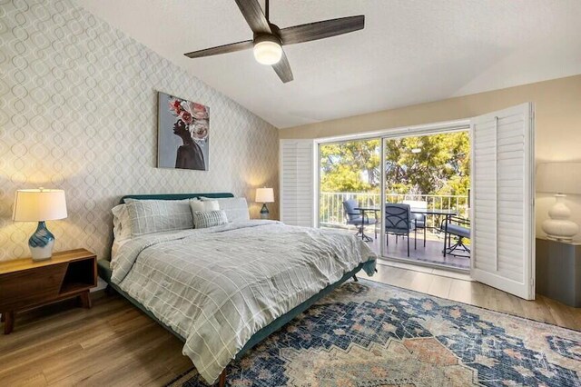 344 Vista Royal Dr, Palm Desert, CA 92211 - bedroom featuring access to outside, lofted ceiling, wood finished floors, and wallpapered walls