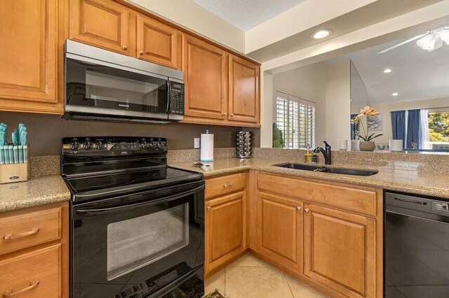 344 Vista Royal Dr, Palm Desert, CA 92211 - kitchen featuring recessed lighting, light stone counters, a sink, light tile patterned floors, and black appliances