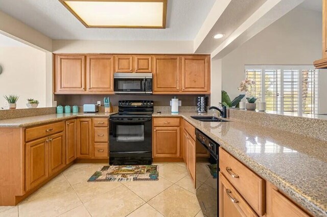 344 Vista Royal Dr, Palm Desert, CA 92211 - kitchen with a sink, a peninsula, light tile patterned floors, and black appliances