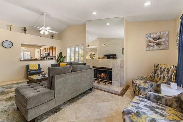 344 Vista Royal Dr, Palm Desert, CA 92211 - living area featuring a tiled fireplace, a ceiling fan, light tile patterned floors, and a wealth of natural light