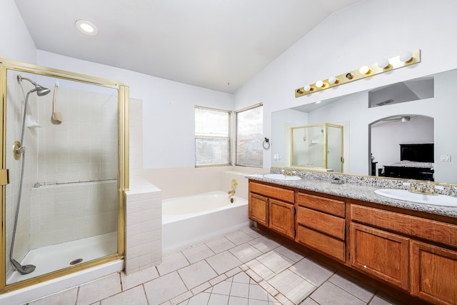 bathroom featuring tile patterned flooring, vanity, vaulted ceiling, and shower with separate bathtub