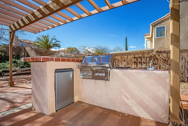 view of patio / terrace with a pergola, grilling area, and exterior kitchen