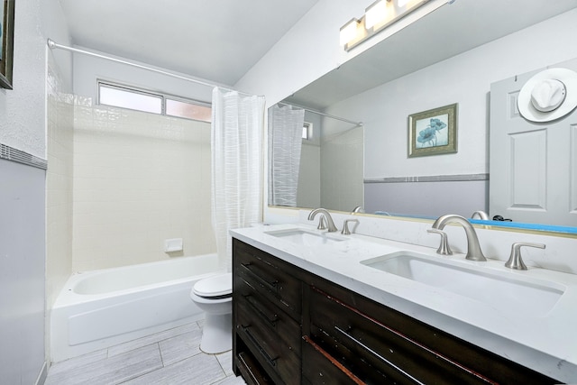 full bathroom featuring shower / bath combo, vanity, and toilet