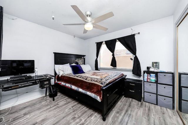 bedroom featuring ceiling fan, a closet, and light wood-type flooring