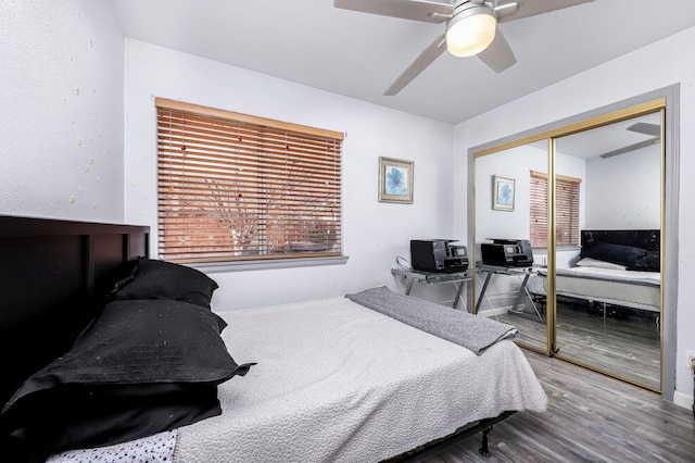 bedroom featuring hardwood / wood-style floors, a closet, and ceiling fan