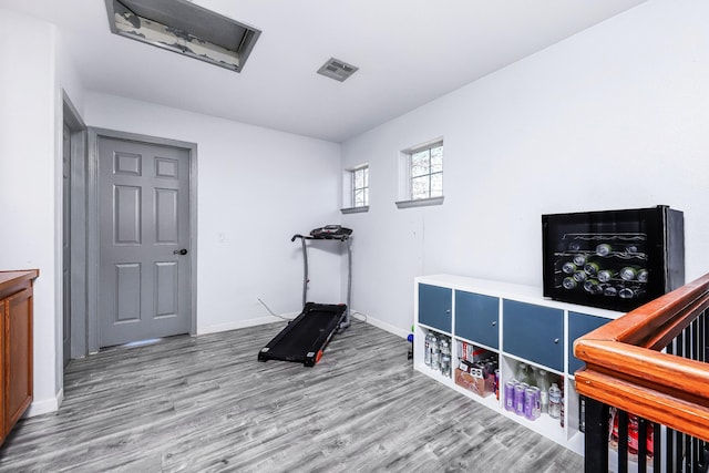 workout area with hardwood / wood-style flooring