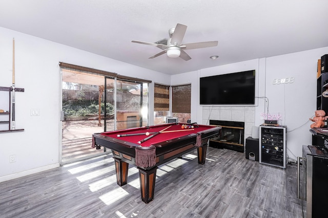 playroom with ceiling fan, beverage cooler, a tile fireplace, billiards, and hardwood / wood-style floors