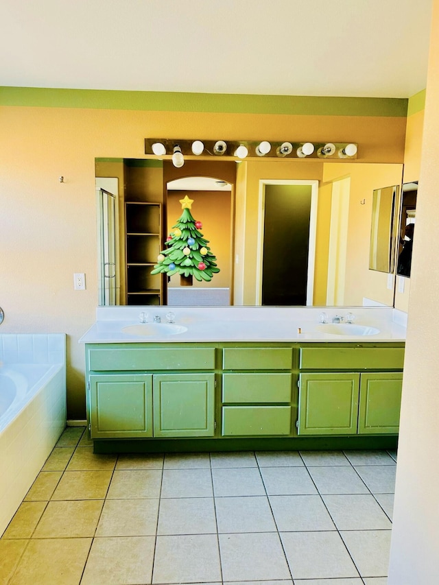 bathroom featuring tiled tub, tile patterned flooring, and vanity