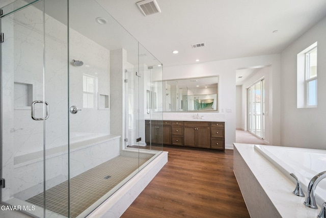 39635 Nicholas Ct, Palmdale, CA 93551 - bathroom featuring vanity, a garden tub, wood finished floors, a marble finish shower, and recessed lighting