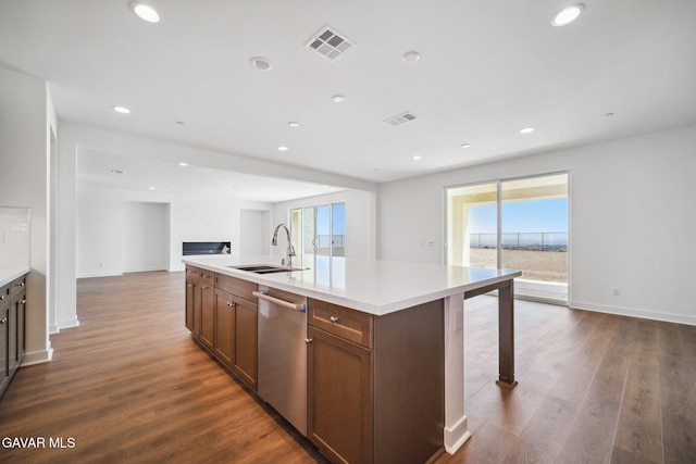 39635 Nicholas Ct, Palmdale, CA 93551 - kitchen with dishwasher, a center island with sink, open floor plan, dark wood finished floors, and light countertops