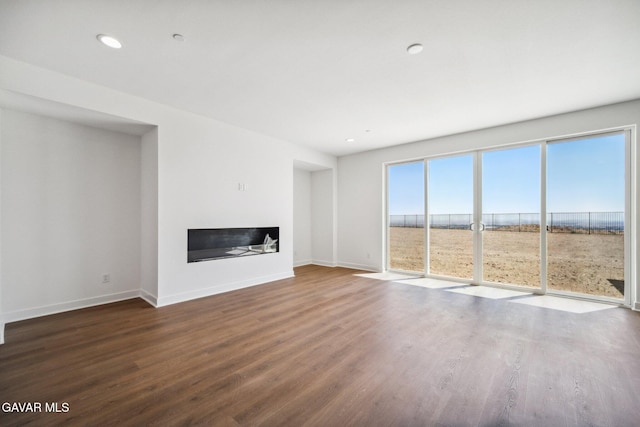 39635 Nicholas Ct, Palmdale, CA 93551 - unfurnished living room with wood finished floors, a glass covered fireplace, and recessed lighting