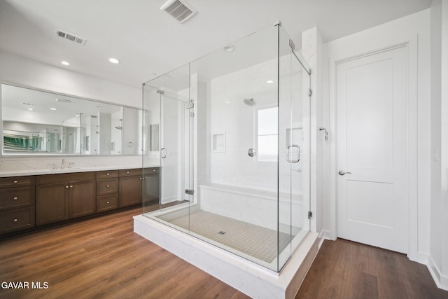 39635 Nicholas Ct, Palmdale, CA 93551 - bathroom featuring wood finished floors, vanity, a shower stall, and recessed lighting