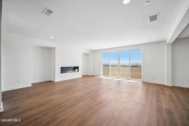 39635 Nicholas Ct, Palmdale, CA 93551 - unfurnished living room with a glass covered fireplace, wood finished floors, and recessed lighting