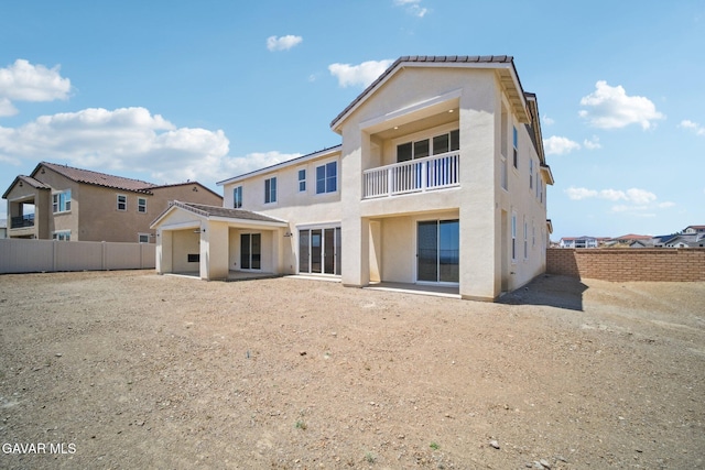 39635 Nicholas Ct, Palmdale, CA 93551 - rear view of house featuring a balcony, stucco siding, a fenced backyard, and a patio area