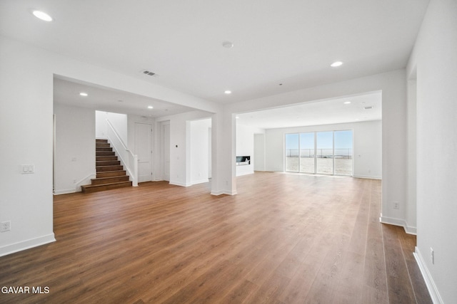 39635 Nicholas Ct, Palmdale, CA 93551 - unfurnished living room featuring stairway, wood finished floors, and recessed lighting