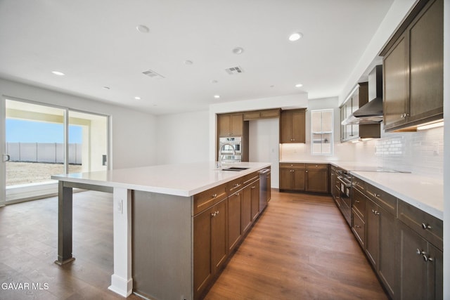 39635 Nicholas Ct, Palmdale, CA 93551 - kitchen featuring wall chimney exhaust hood, decorative backsplash, dark wood-type flooring, appliances with stainless steel finishes, and recessed lighting