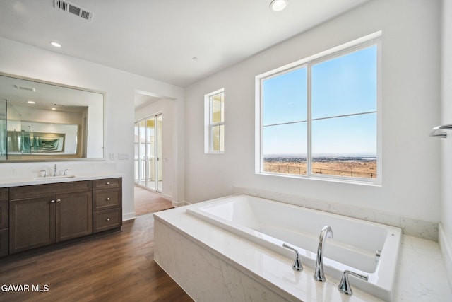 39635 Nicholas Ct, Palmdale, CA 93551 - bathroom with vanity, a bath, wood finished floors, and recessed lighting