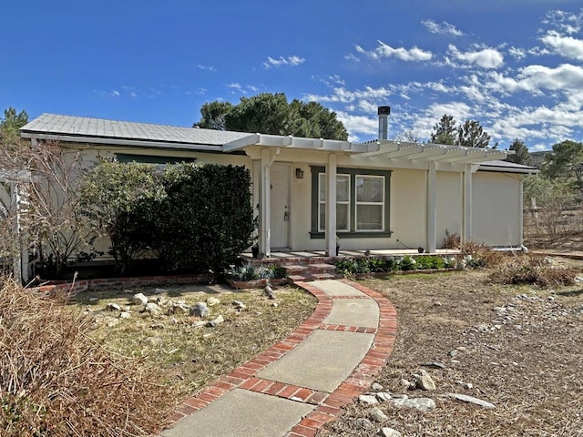 view of front facade featuring covered porch and stucco siding