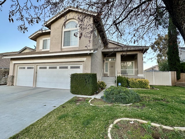 view of front facade with stucco siding, a front lawn, fence, concrete driveway, and a garage