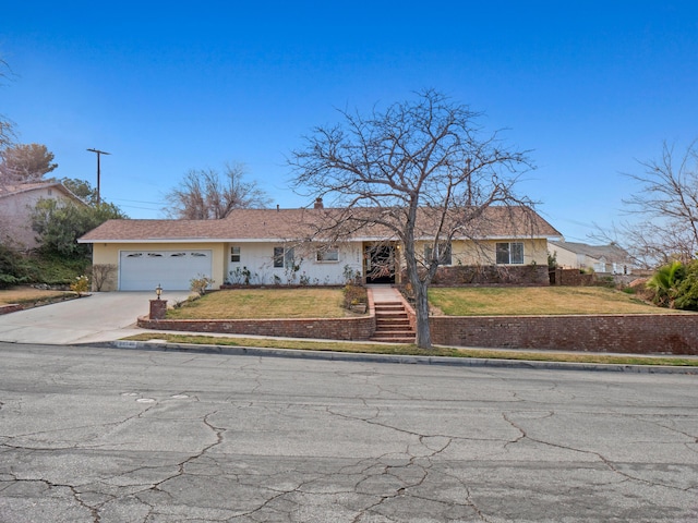 single story home featuring a garage and a front lawn