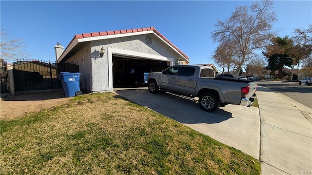 view of property exterior with a garage and a yard