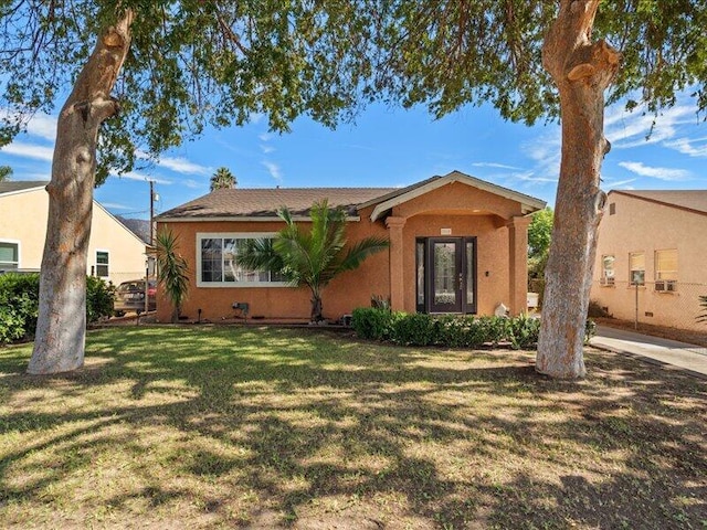 view of front of property with a front lawn and stucco siding