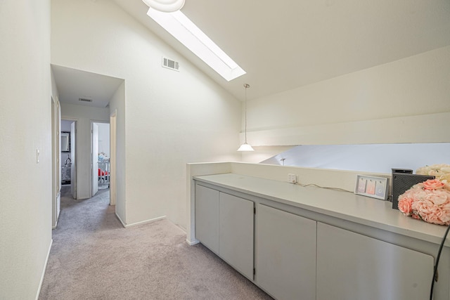 43661 Bravo Ln, Lancaster, CA 93535 - corridor featuring lofted ceiling, a skylight, and light carpet