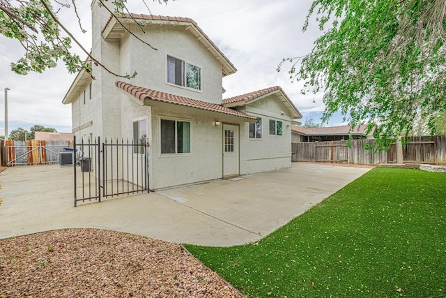 43661 Bravo Ln, Lancaster, CA 93535 - rear view of house featuring a gate, stucco siding, a tile roof, a patio area, and cooling unit
