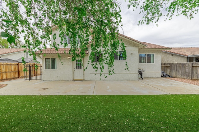 43661 Bravo Ln, Lancaster, CA 93535 - back of property with a tile roof, stucco siding, a patio, and a fenced backyard