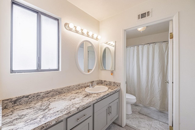 43661 Bravo Ln, Lancaster, CA 93535 - full bath featuring toilet, vanity, marble look tiles, and a shower with shower curtain