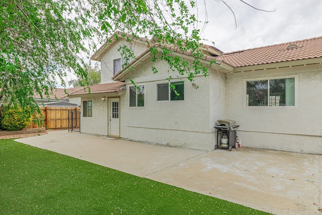 43661 Bravo Ln, Lancaster, CA 93535 - back of property with a tile roof, fence, and stucco siding