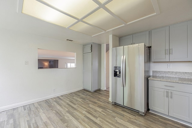 43661 Bravo Ln, Lancaster, CA 93535 - kitchen featuring stainless steel fridge, gray cabinets, light wood-style floors, and baseboards