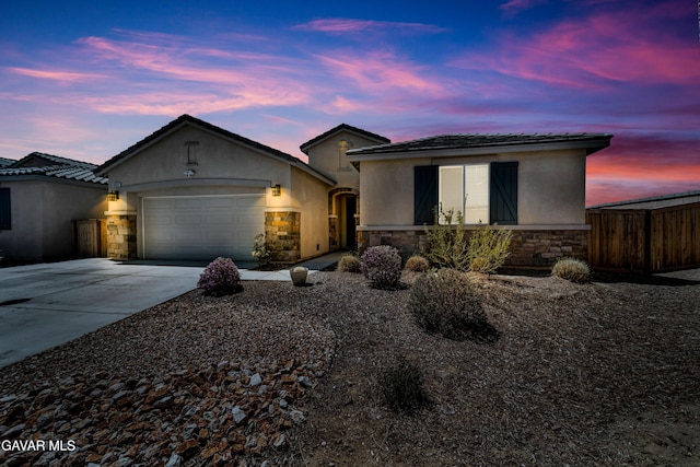 3932 Birchwood Ave, Rosamond, CA 93560 - ranch-style house with stone siding, stucco siding, driveway, and an attached garage