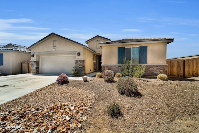 3932 Birchwood Ave, Rosamond, CA 93560 - view of front of house featuring stone siding, driveway, stucco siding, and a garage